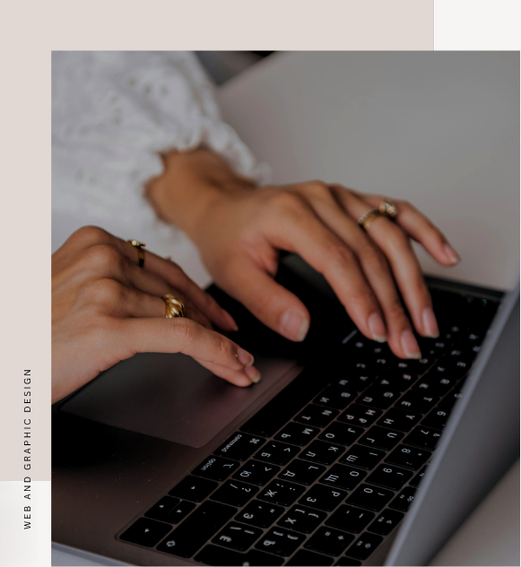 woman with pretty hands typing on the her grey laptop and black keyboard