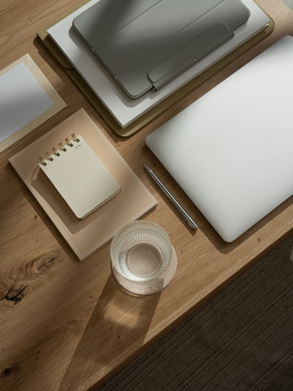 desk with tech notebook and a glass